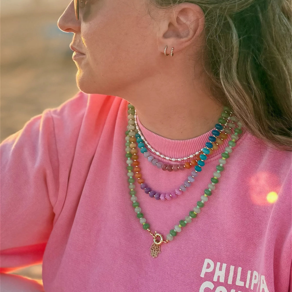 Colorful jade and freshwater pearl necklaces worn layered together