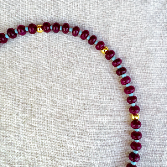 Detail view of Violetta necklace with burgundy and turquoise-coloured beads
