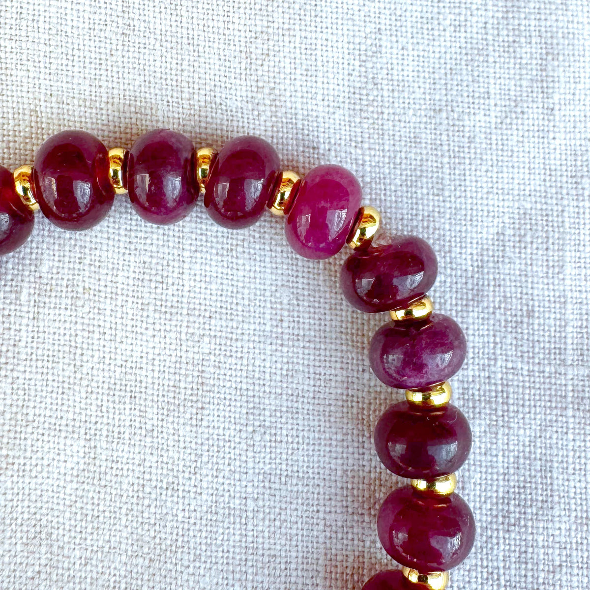 Close-up detail of Granada bracelet with burgundy jade beads and gold-plated accents
