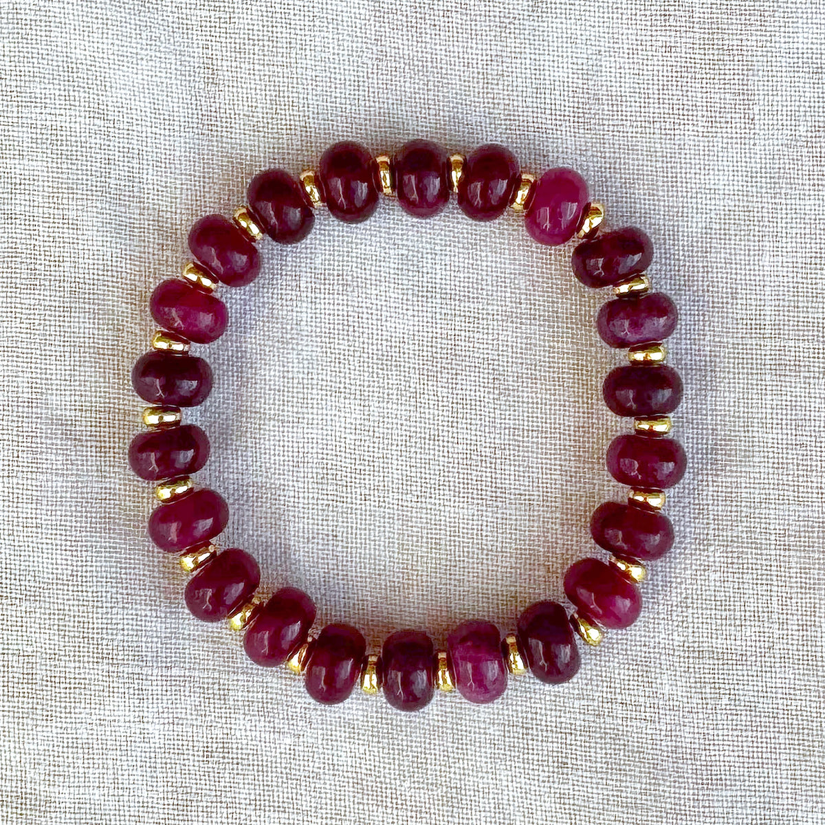 Granada burgundy jade bead bracelet with gold-plated spacer beads, full product view