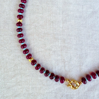 Close-up of Violetta necklace featuring burgundy jade beads and gold-plated details