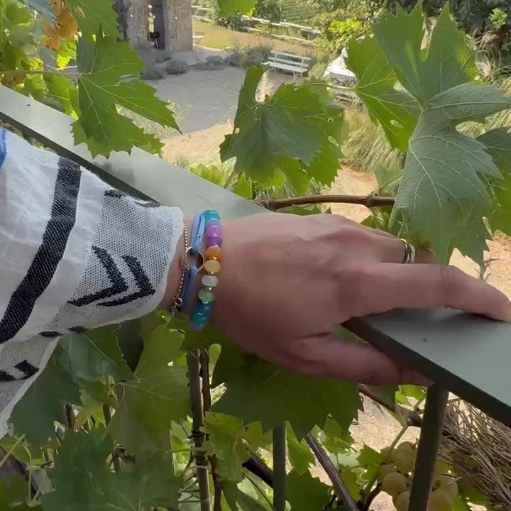 Colorful rainbow jade bead bracelet worn on wrist