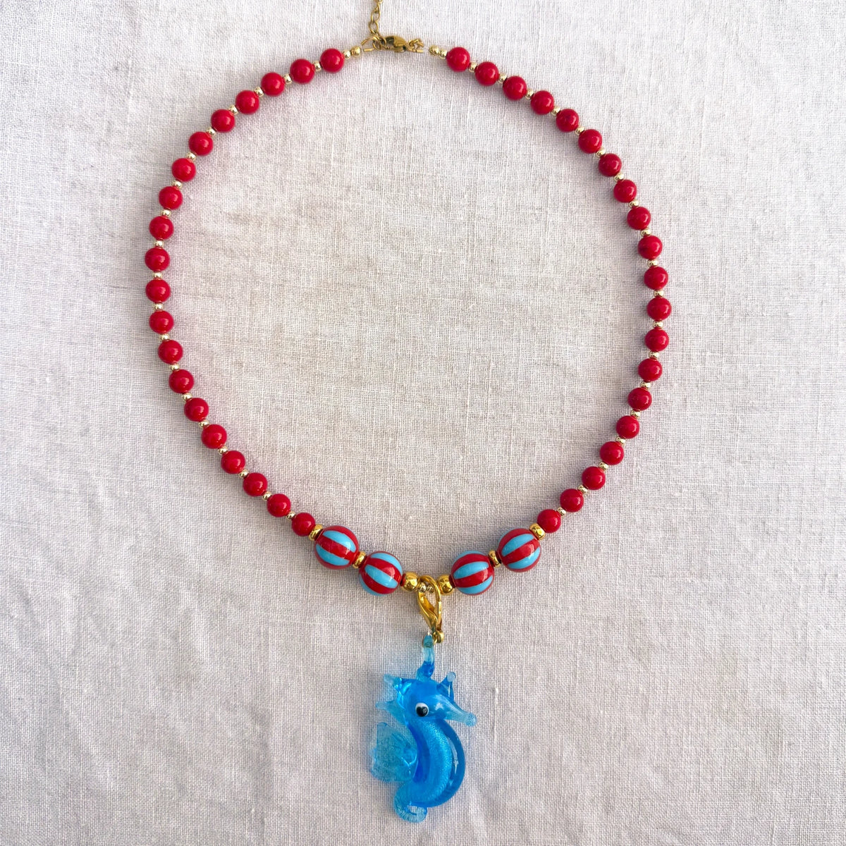 Red jade bead necklace with blue glass seahorse pendant Señorita Seahorse by Studio Gløra